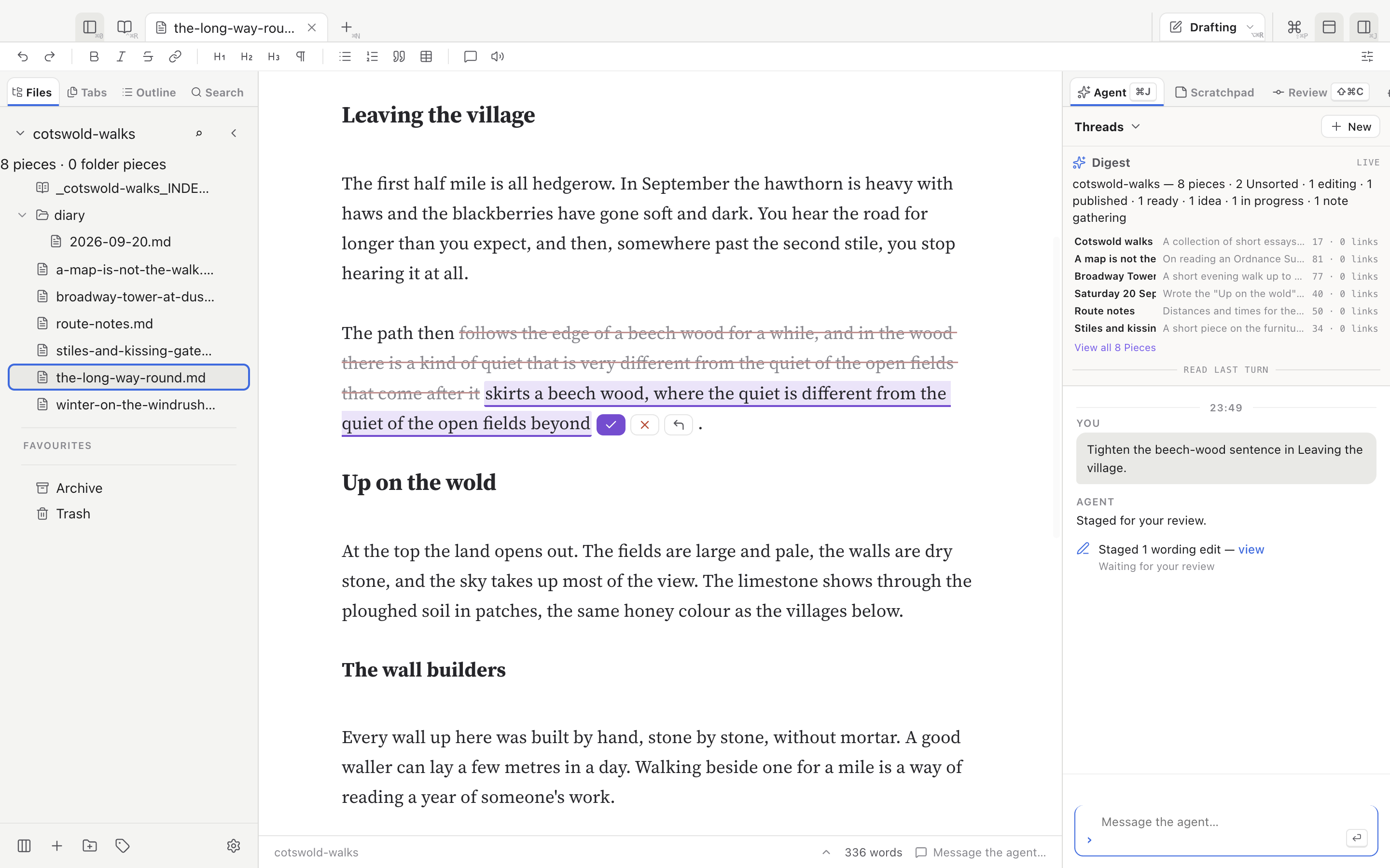 WriteFlex with a sample essay, The long way round, open in Drafting mode. The Files tree is on the left. In the text, one sentence shows a struck-through original and a shorter replacement with accept and reject buttons. The Agent pane on the right shows the request and the reply: staged one wording edit, waiting for your review.